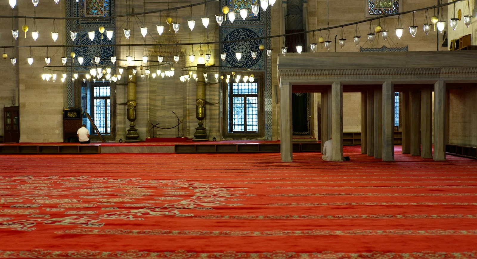 A mosque with red carpet and warm light